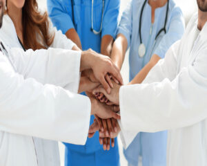 Doctors and nurses stacking hand