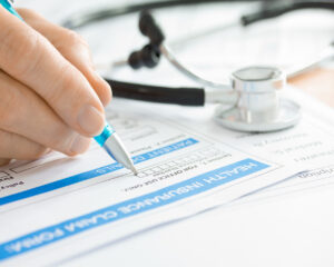 Doctor with Medical Insurance Claim Form and Stethoscope