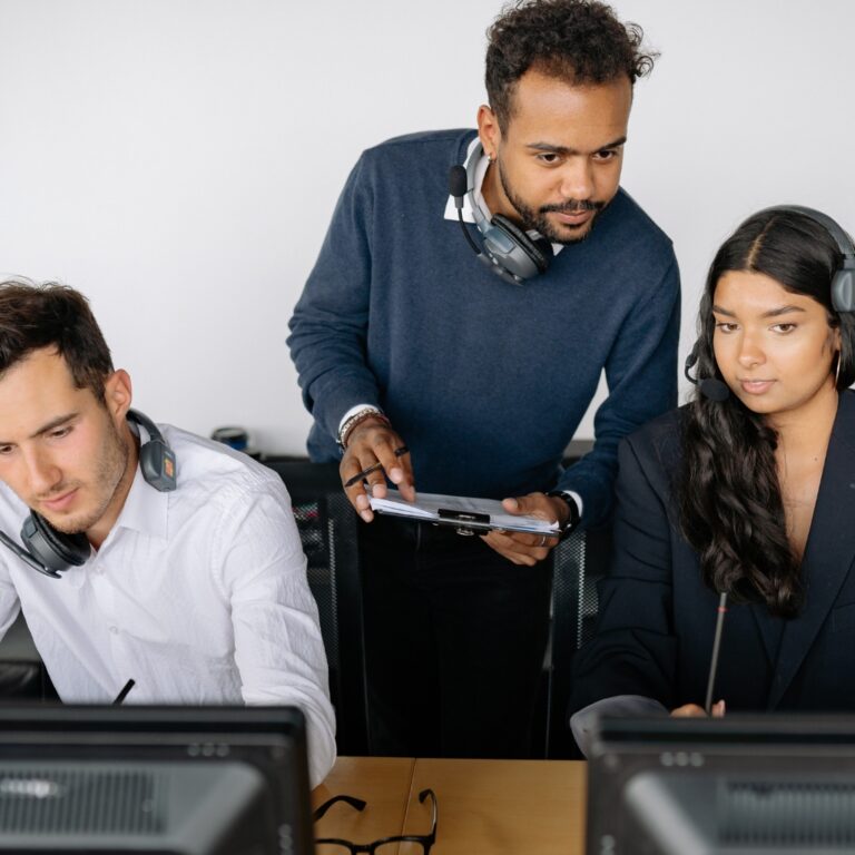 three people looking at data to understand issues, assessing a situation