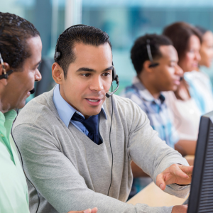 man coaching a call center agent on the floor